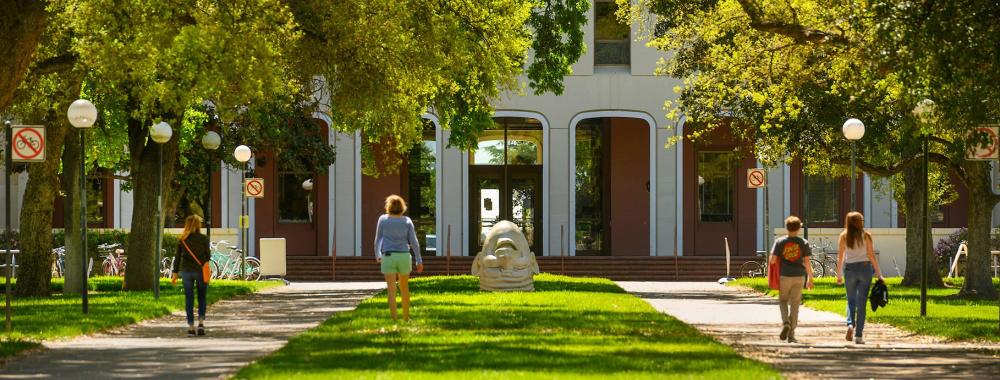 people walking in front of mrak hall