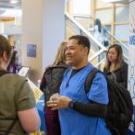 UC Davis Health employees smiling and talking at welcome. 